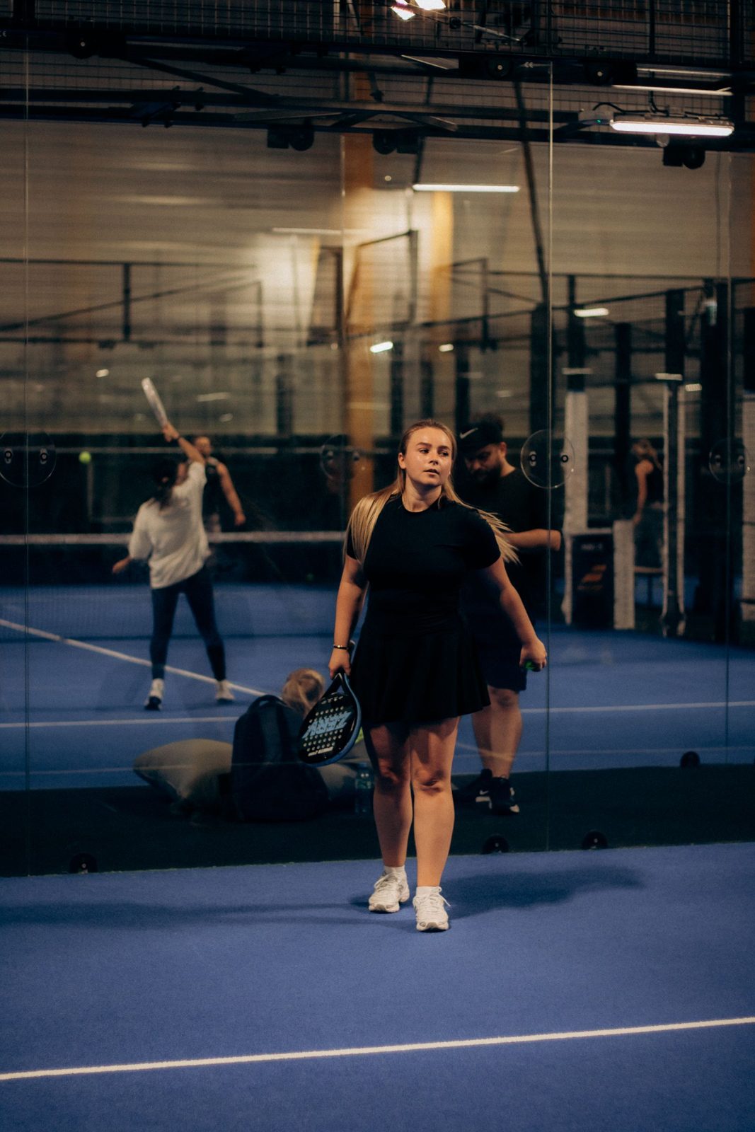 Group of players on an indoor padel court